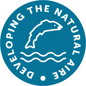 A fish is leaping in the middle of the Developing the Natural Aire logo