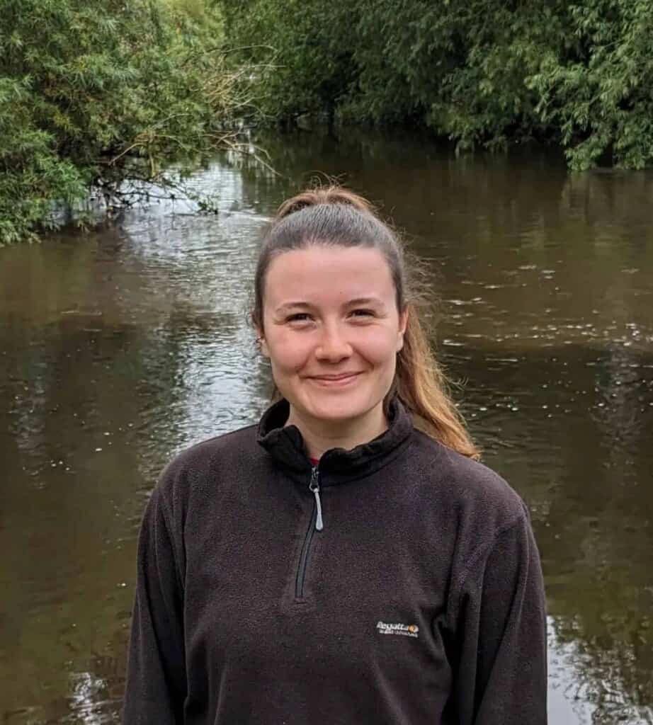 Olivia Holmes standing in front of a river
