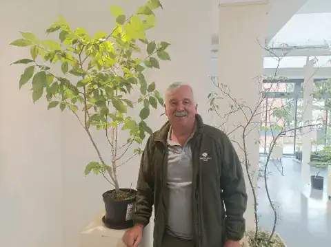 Roger stood in front of a tree