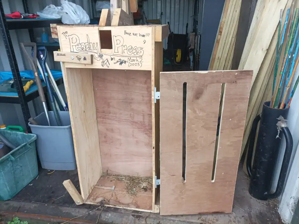 A closeup of a roughly constructed fruit press