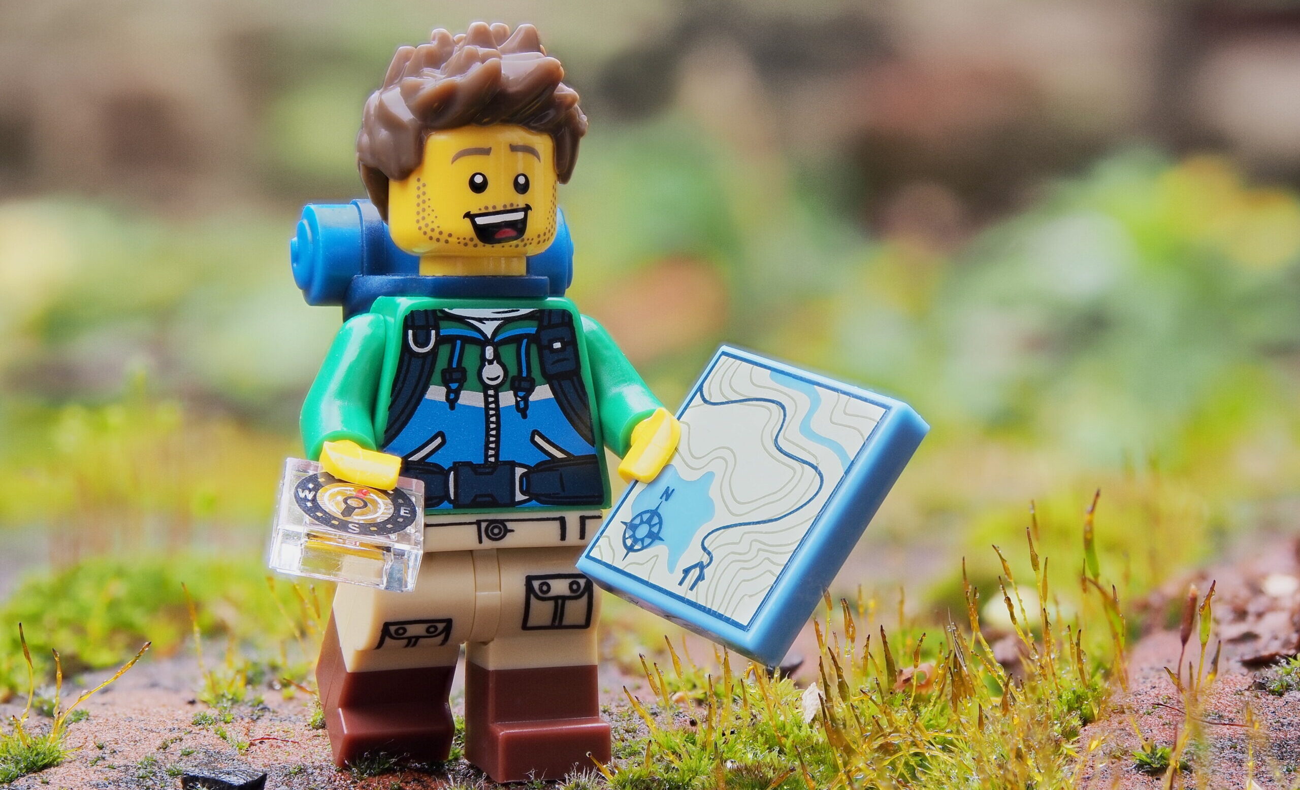 A lego figure representing an environmental engineer with a map in his hand